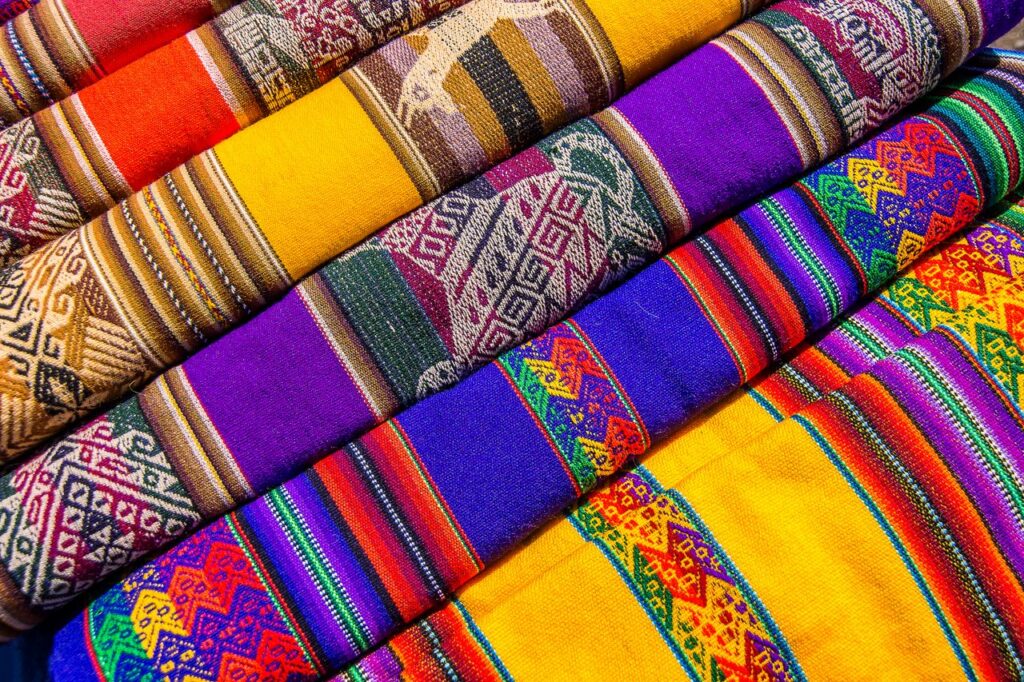 Vibrant woven fabrics featuring intricate geometric designs and rich colors, perfect for cultural and textile projects.